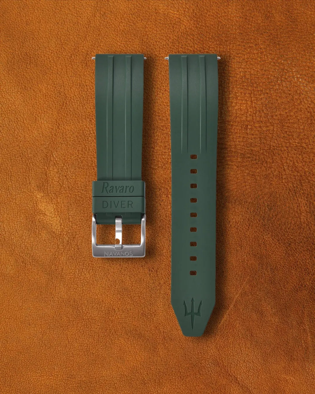 Piton green Ravaro Diver FKM rubber watch strap with ribbed design, embossed "Ravaro DIVER" keeper, trident logo on tip, stainless steel tang buckle engraved "NAVANOS", quick-release spring bars, and adjustment holes, displayed on brown suede background.