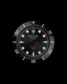 Navanos Ravaro dive watch dial and bezel close-up featuring black dial with cream luminous markers, trident logo, red "Ravaro" script, "Sport Diver 300 Meters" and "Chronometer Officially Certified ISO 6425" text, black ceramic unidirectional bezel insert with cream numerals, and luminous pip at 12 o'clock, on black background.