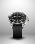 Navanos Ravaro Swiss automatic dive watch with black dial, cream luminous markers and hands, red "Ravaro" script, black ceramic unidirectional bezel, 300m water resistance, COSC-certified Soprod P024 movement, sapphire crystal, and black FKM rubber strap, angled studio shot on light gray background.