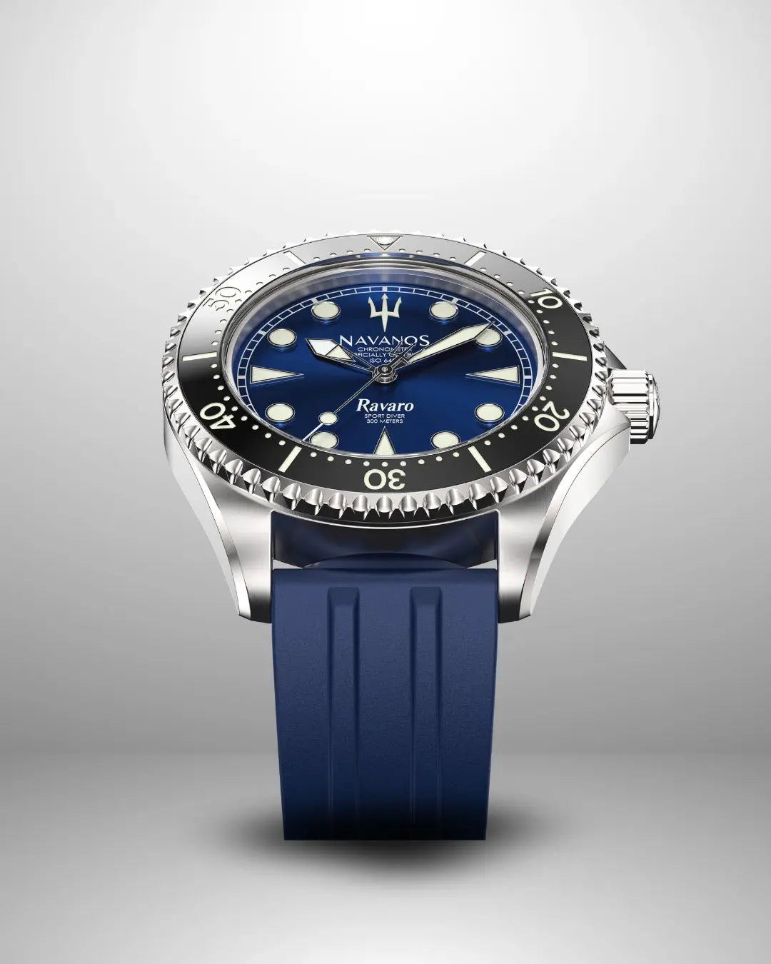 Navanos Ravaro Swiss automatic dive watch with blue sunburst dial, cream luminous markers and hands, black ceramic unidirectional bezel, 300m water resistance, COSC-certified Soprod P024 movement, sapphire crystal, and matching navy blue FKM rubber strap, angled studio shot on light gray background.