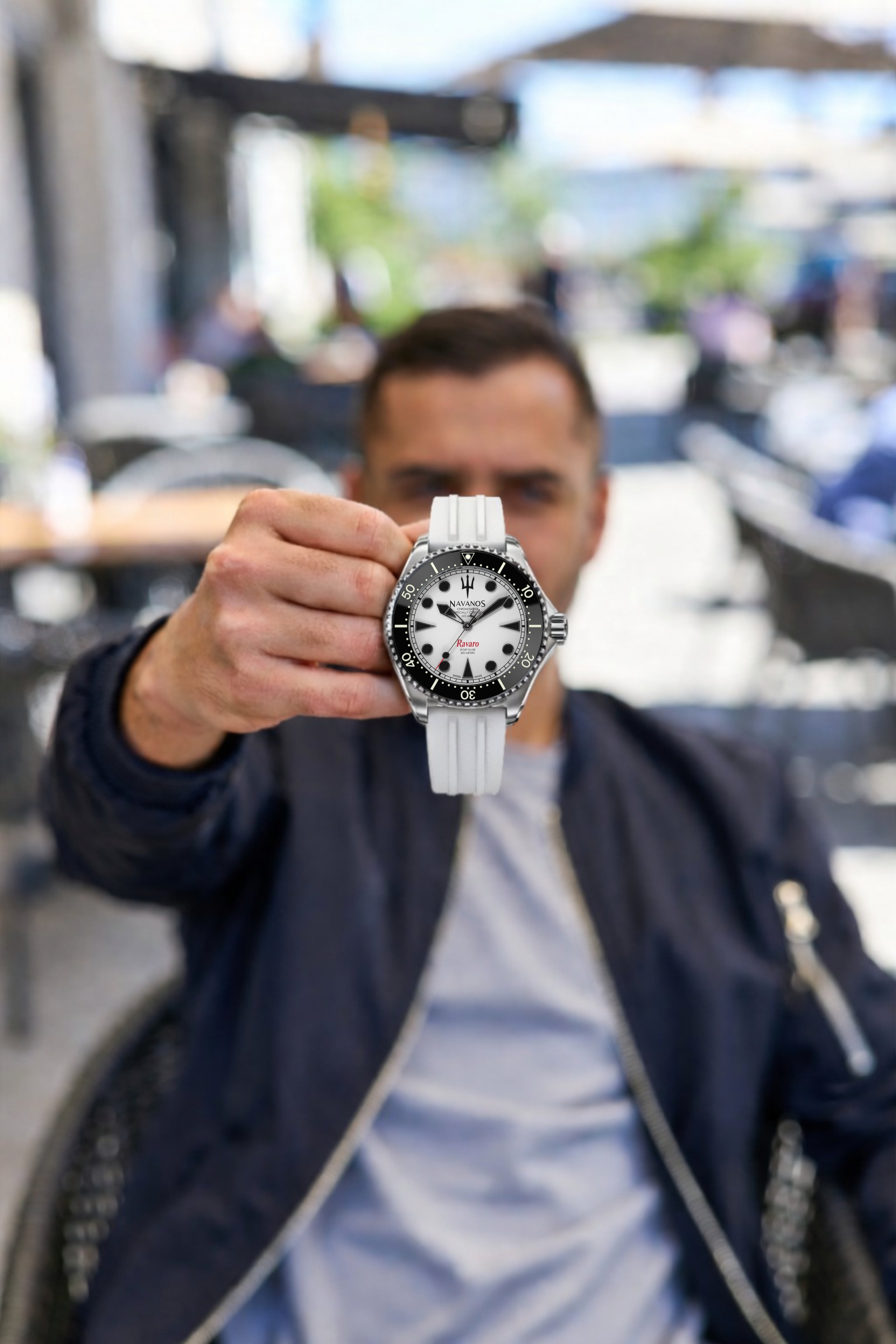 navanos ravaro diver coral white dial held in hand focus shot swiss dive watch presentation