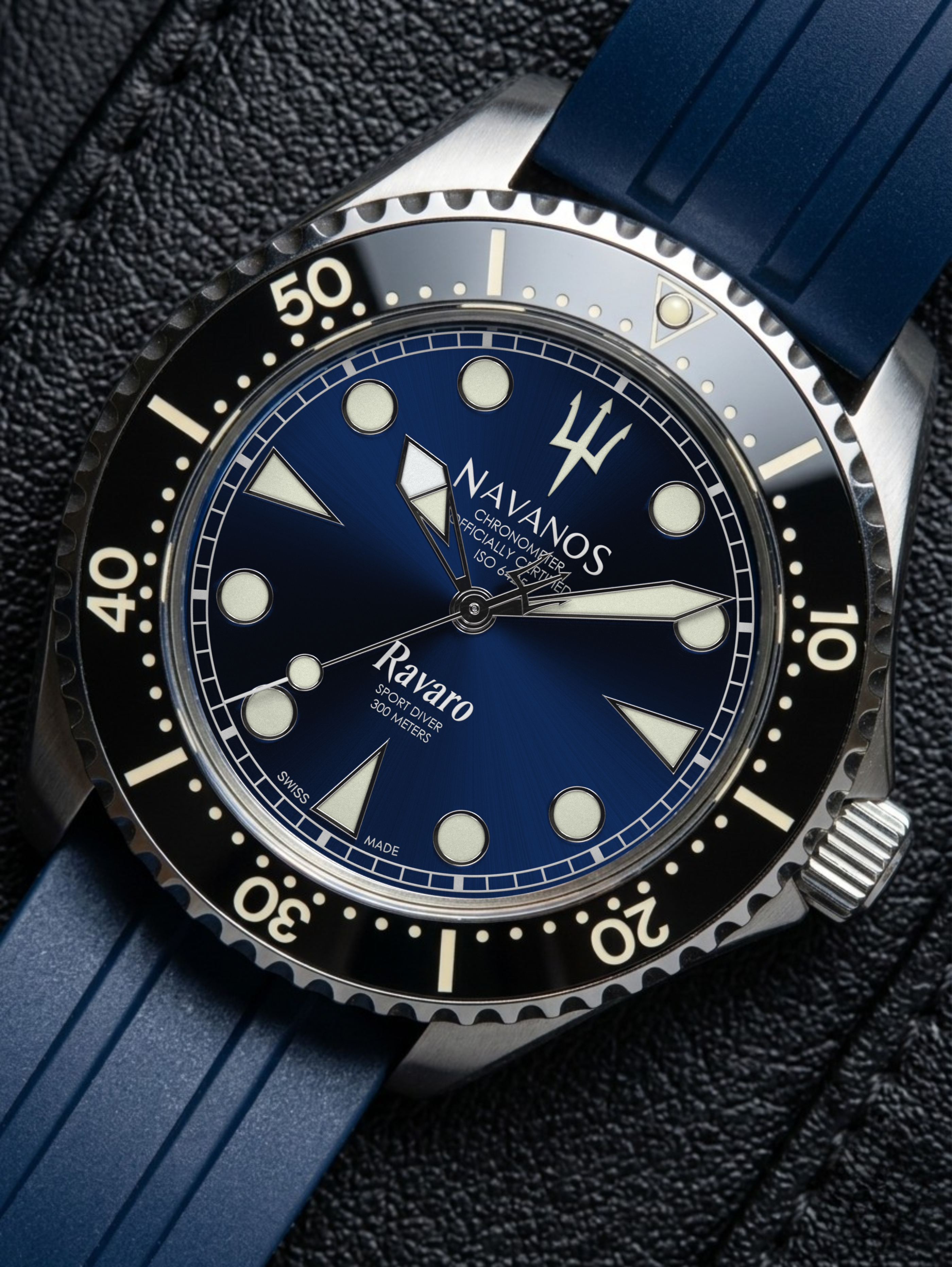 Navanos Ravaro Diver luxury dive watch with nautical blue dial black bezel and rubber strap close-up on textured surface