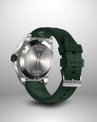 Navanos Ravaro Swiss automatic dive watch caseback view showing engraved trident logo, "Ravaro Sport Diver" script, COSC-certified marking, solid screw-down stainless steel caseback, paired with green FKM rubber strap featuring embossed "Ravaro DIVER" and "NAVANOS" branding, studio shot on light gray background.