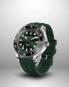 Navanos Ravaro Swiss automatic dive watch side view highlighting green sunburst dial, cream luminous markers and hands, black ceramic unidirectional bezel, signed crown with protectors, 300m water resistance, COSC-certified Soprod P024 movement, and matching piton green FKM rubber strap, studio shot on light gray background.