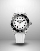 Navanos Ravaro Swiss automatic dive watch with white dial, luminous black markers, black ceramic unidirectional bezel, red accents, 300m water resistance, COSC chronometer certification, and white FKM rubber strap, on light gray background.
